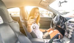 woman showing the keys inside a sport car. sexy business woman ready to drive. concept about leasing a car