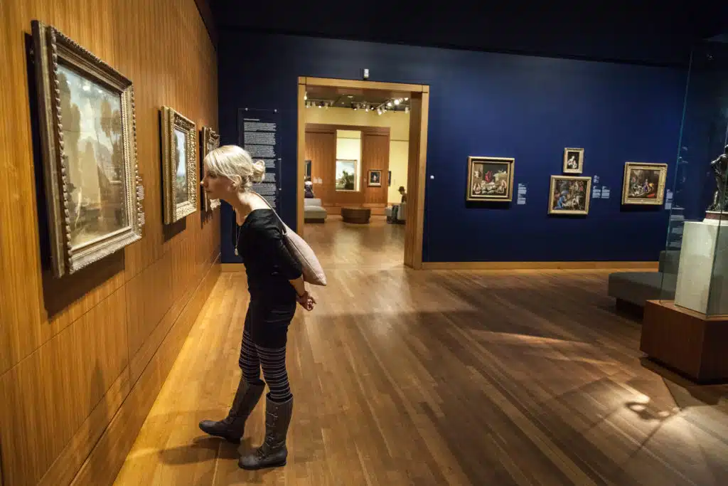 Montreal, Canada - Montreal Fine Arts Museum Room with Paintings on the wall and Young Adult looking at it.