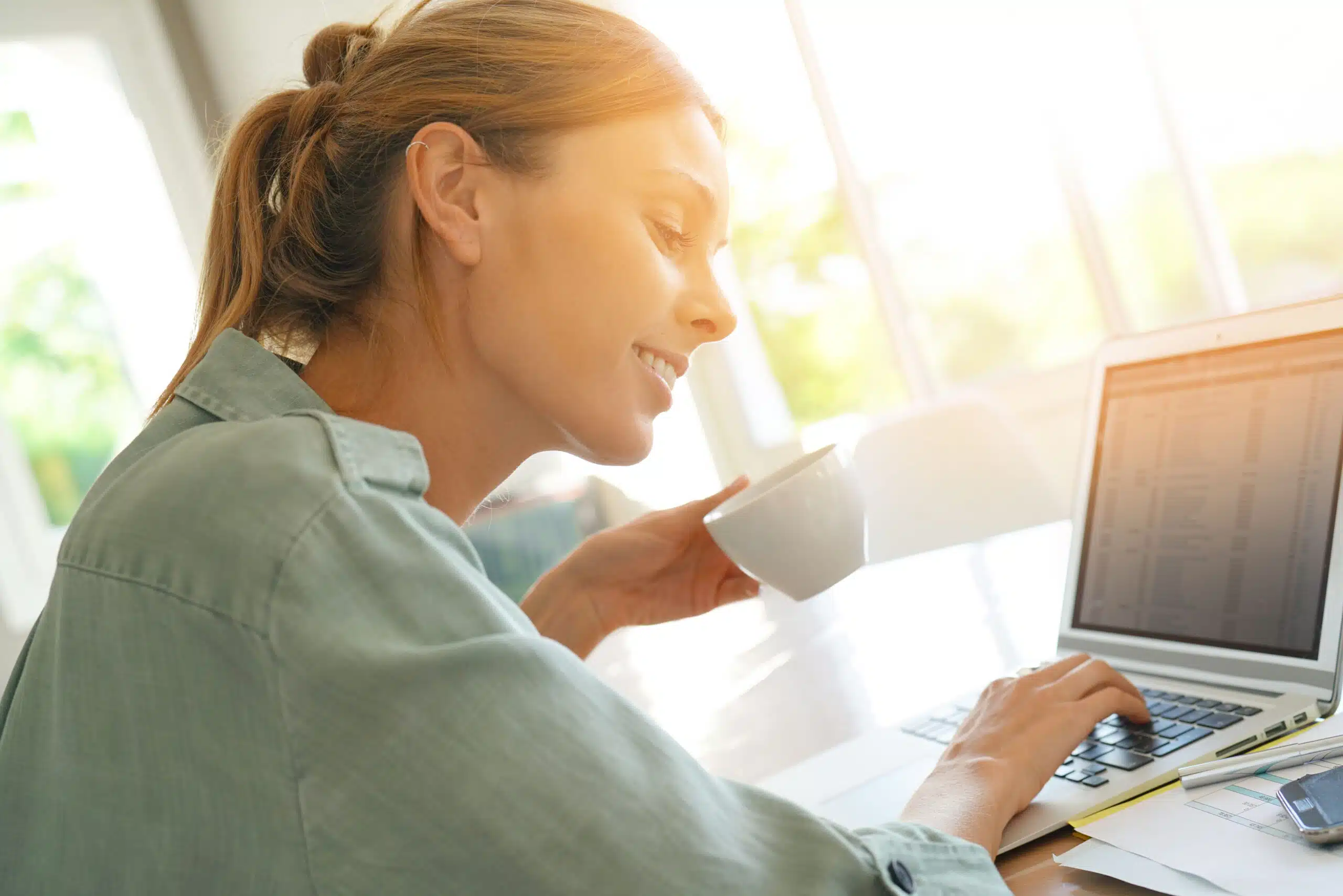 Trendy girl working from home on laptop and making money