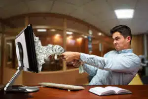 Businessman pulling out money of the computer screen for earning multiple income streams