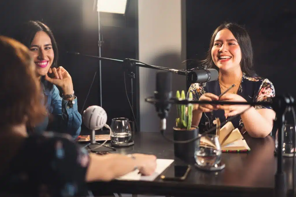 three women speaking on a podcast