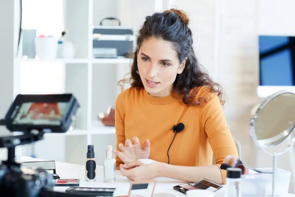 A woman testing skin care products on camera